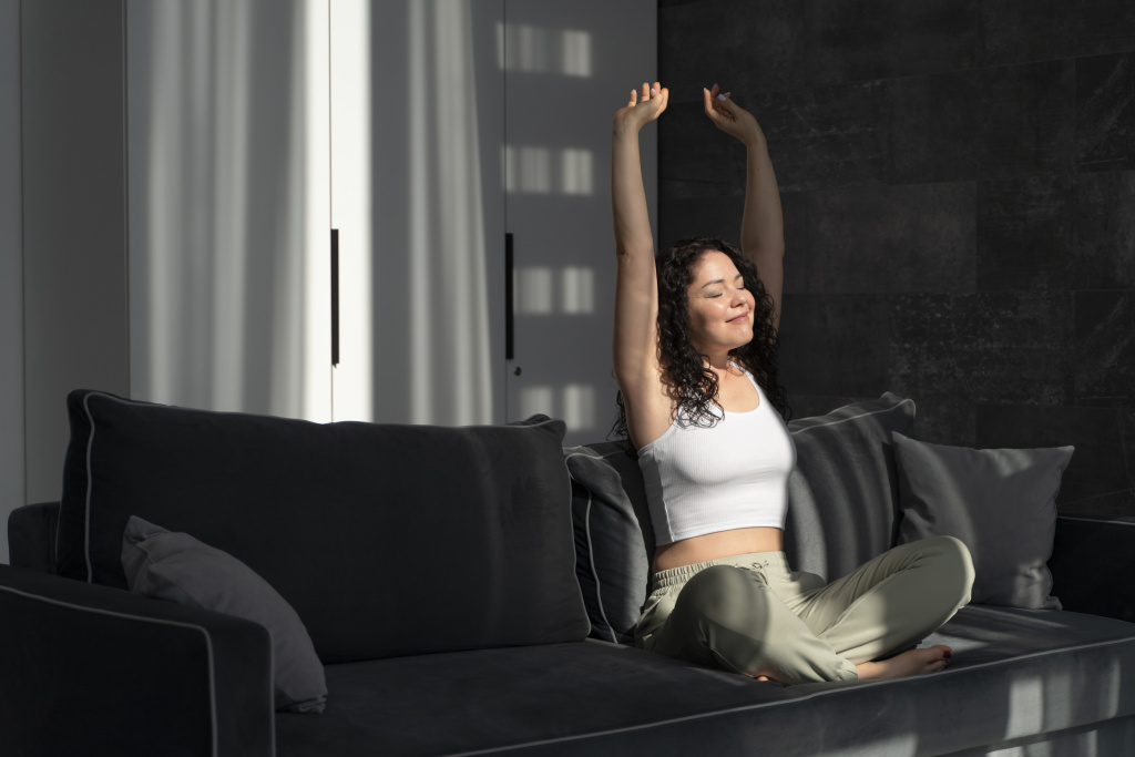 full-shot-woman-stretching-on-couch.jpg